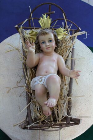 Bambino Gesù Benedicente in pasta Madera, finitura seconda occhi azzurri.